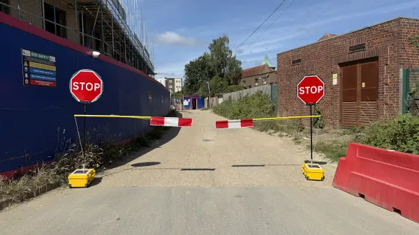 Stop/Go poles with flag barrier attached.