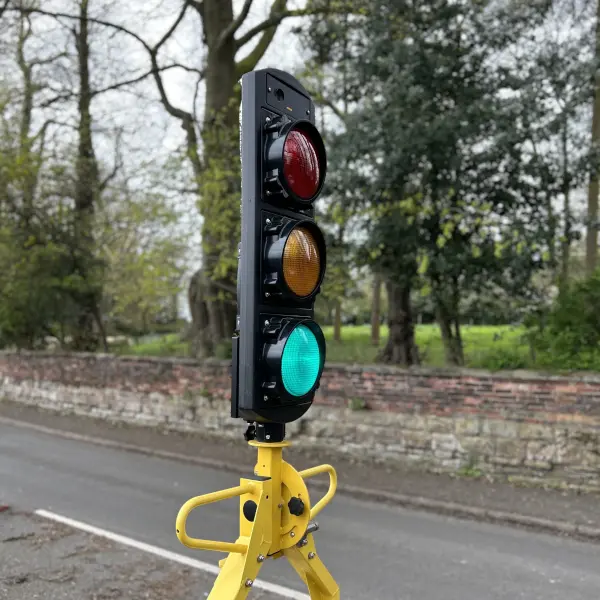 Traffic signal head showing green on road networks.